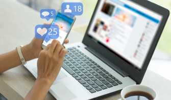 Computer and mobile device displaying social media news feeds.